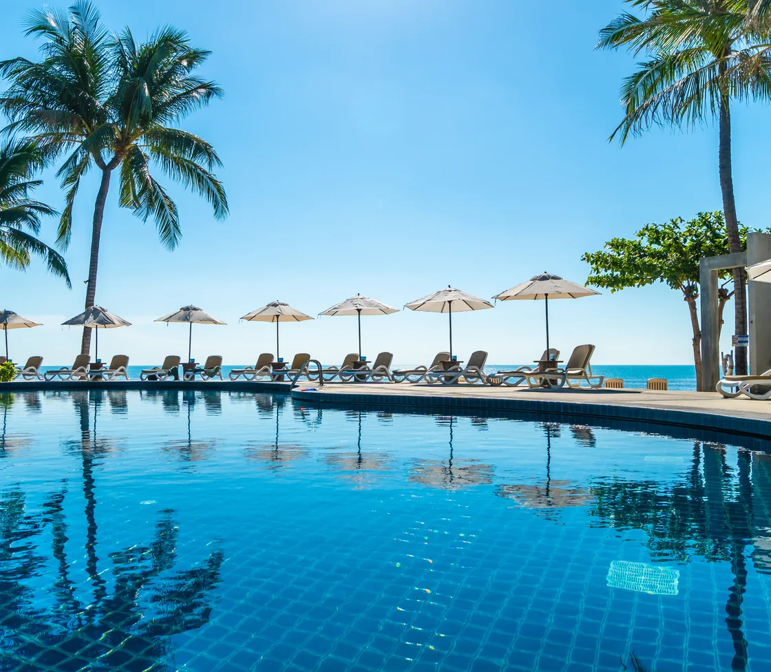 An infinity pool overlooking the sea at a coastal resort.